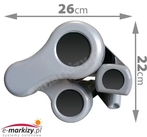 Grafika techniczna przedstawia rzut boczny profilu, jaki posiada markiza Mezzo po całkowitym złożeniu, co pozwala na ocenę jej kompaktowości. Na jasnoszarych elementach konstrukcyjnych, obejmujących uchwyt rury nawojowej oraz ramiona, naniesiono wymiary określające przestrzeń zajmowaną przez urządzenie. Szerokość złożonego mechanizmu wynosi 26 cm, natomiast jego wysokość to 22 cm, co zaznaczono za pomocą szarych strzałek wymiarowych. Widok ten precyzyjnie obrazuje, jak ściśle poszczególne podzespoły aluminiowego stelaża przylegają do siebie, minimalizując wystawanie markizy poza obrys ściany lub sufitu po zwinięciu materiału.