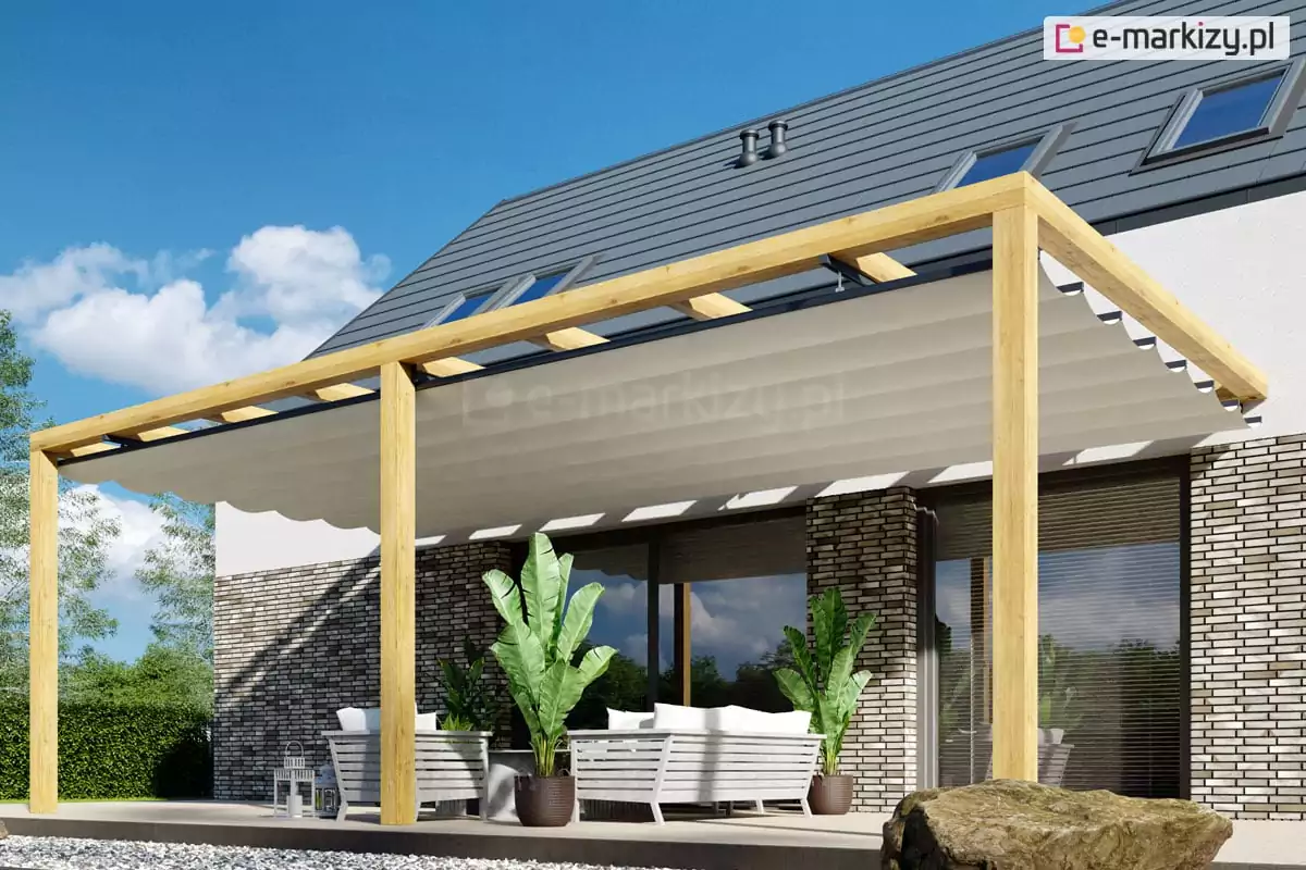 Pergola tarasowa drewniana Juko przyścienna o szerokości powyżej 5m, z dachem rzymskim, który przykrywa całą konstrukcję, pod którą ustawiono meble wypoczynkowe oraz dwie duże rośliny zielone w brązowych doniczkach. Przy tarasie ułożono wielki głaz. W tle widoczne niebieskie niebo częściowo pokryte białymi chmurkami.