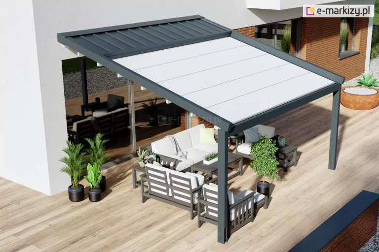 Nowoczesna pergola przyścienna Moderno o konstrukcji aluminiowej w kolorze antracytowym, zamontowana nad przestronnym tarasem wyłożonym deskami o naturalnym odcieniu drewna. Zadaszenie składa się z dwóch części: stałego daszka systemowego w kolorze antracytowym chroniącego zwinięty materiał oraz rozwiniętej, jasnej tkaniny technicznej podzielonej na równe segmenty. Pod pergolą zaaranżowano strefę wypoczynkową z szarymi meblami tarasowymi o konstrukcji drewnianej, białymi poduszkami, stolikami kawowymi oraz roślinami w ozdobnych czarnych donicach. Konstrukcja przylega do białej elewacji budynku z dużym przeszkleniem, w którym odbija się otoczenie, a w tle widoczny jest fragment ściany z czerwonej cegły i dekoracyjna misa z roślinnością.