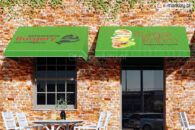 Markiza trójkątna z nadrukowaną reklamą burgerów z logiem i hasłem reklamowym restauracji