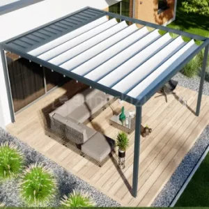 Pergola Luxury w wersji wolnostojącej z aluminiową konstrukcją i rozwijaną tkaniną dachową tworzy eleganckie, pełne zadaszenie nad drewnianym tarasem. Stabilna konstrukcja wsparta na czterech nogach osłania zestaw ogrodowy, otoczony żwirem dekoracyjnym, trawami i nowoczesną elewacją domu.